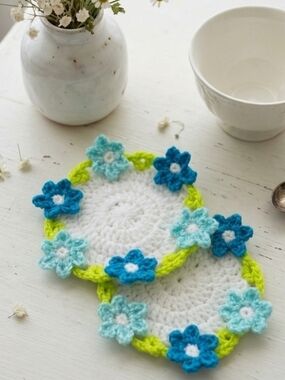 Handmade White Crochet Flower Coasters with Blue and Aqua Accents